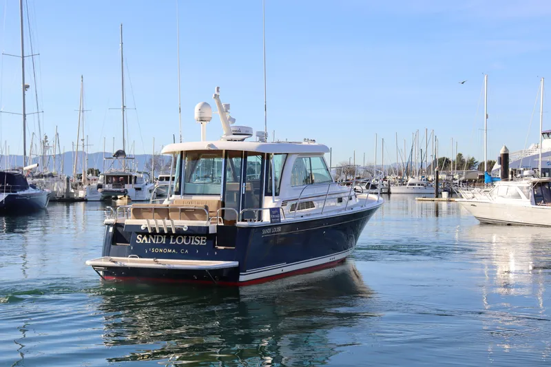 Slide: The Image of 2013 Sabre 38 Salon Express yacht in marina, clear sky, calm water. - 6