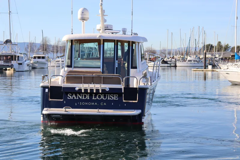 Slide: The Image of 2013 Sabre 38 Salon Express boat in marina, labeled "Sandi Louise," Sonoma, CA. - 7