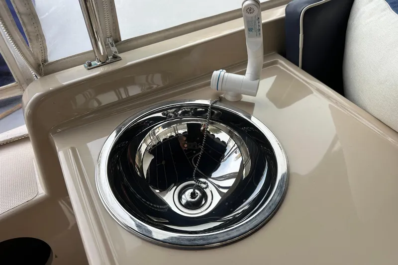 Slide: The Image of Stainless steel sink with faucet on 2011 Duffy 22 boat interior. - 11