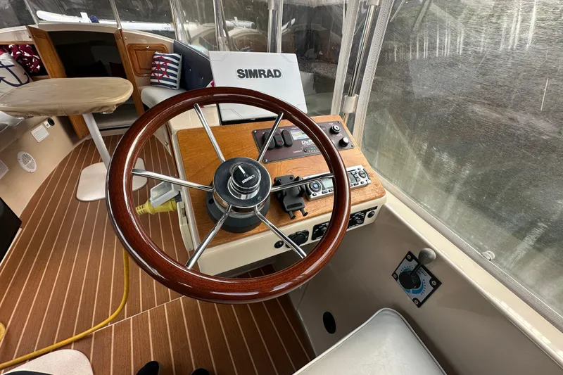 Slide: The Image of Steering wheel and controls of a 2011 Duffy 22 boat with Simrad equipment. - 5