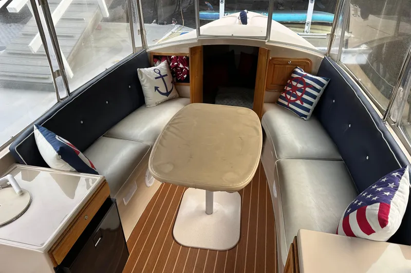 Slide: The Image of Interior of 2011 Duffy 22 boat with nautical-themed cushions and seating area. - 6