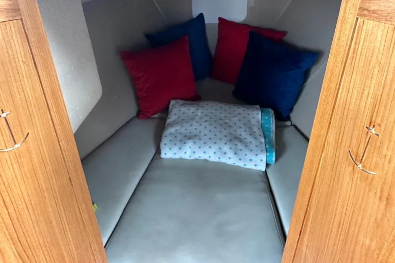 Slide: The Image of Cozy cabin interior of 2011 Duffy 22 boat with colorful pillows and blanket. - 7