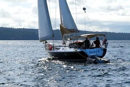 Slide: The Image of Sailing yacht Jeanneau Sun Odyssey 45.2, 1999, on open water with crew. - 1