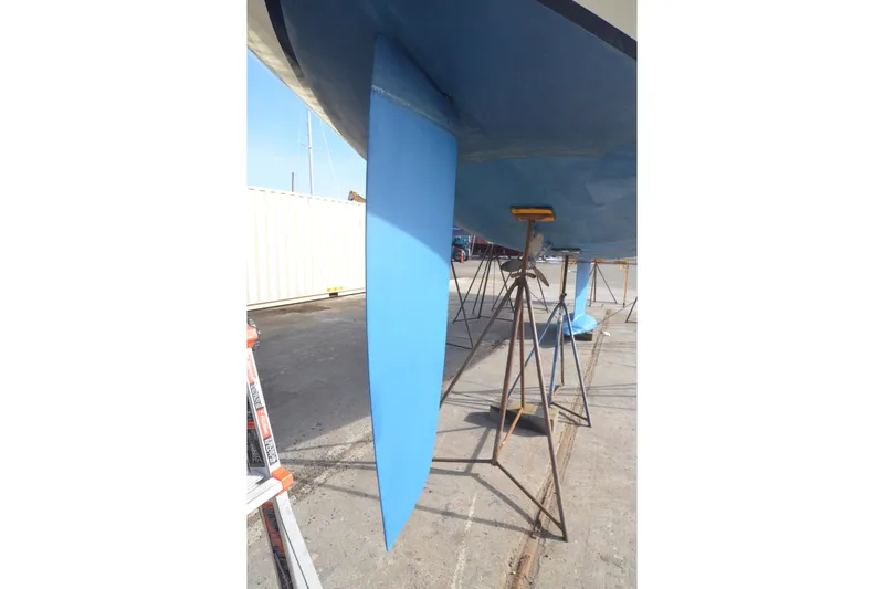 Slide: The Image of Jeanneau Sun Odyssey 45.2 sailboat keel, 1999 model, on stands for maintenance. - 12