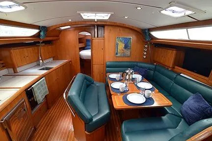 Slide: The Image of Interior of 1999 Jeanneau Sun Odyssey 45.2 yacht with dining area and kitchen. - 19