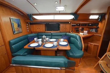 Slide: The Image of Interior of 1999 Jeanneau Sun Odyssey 45.2 yacht with dining area and navigation station. - 21