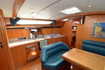 Slide: The Image of Interior of 1999 Jeanneau Sun Odyssey 45.2 yacht with wood finish and blue seating. - 22