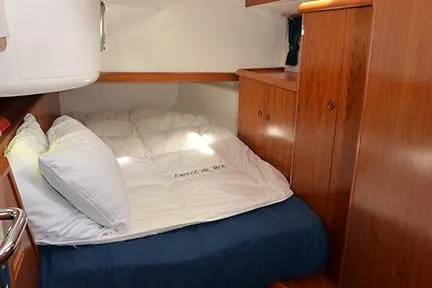 Slide: The Image of Cozy cabin interior of 1999 Jeanneau Sun Odyssey 45.2 sailboat with wooden furnishings. - 26