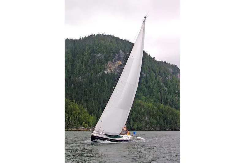 Slide: The Image of Sailing yacht Jeanneau Sun Odyssey 45.2, 1999, cruising near forested coastline. - 3