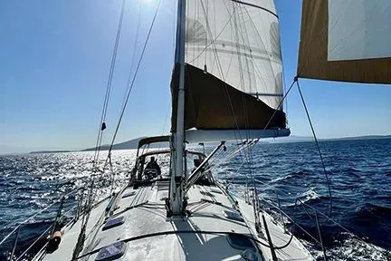 Slide: The Image of Sailing Jeanneau Sun Odyssey 45.2, 1999 model, on open sea under clear blue sky. - 4