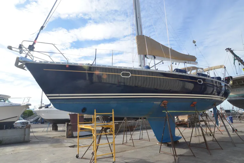 Slide: The Image of Jeanneau Sun Odyssey 45.2 sailboat from 1999 on dry dock, blue hull, clear sky. - 6
