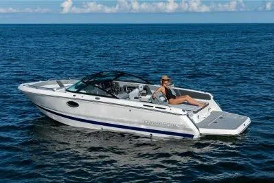 Slide: The Image of 2026 Chaparral SSX 4 boat cruising on open water with a relaxed passenger. - 1