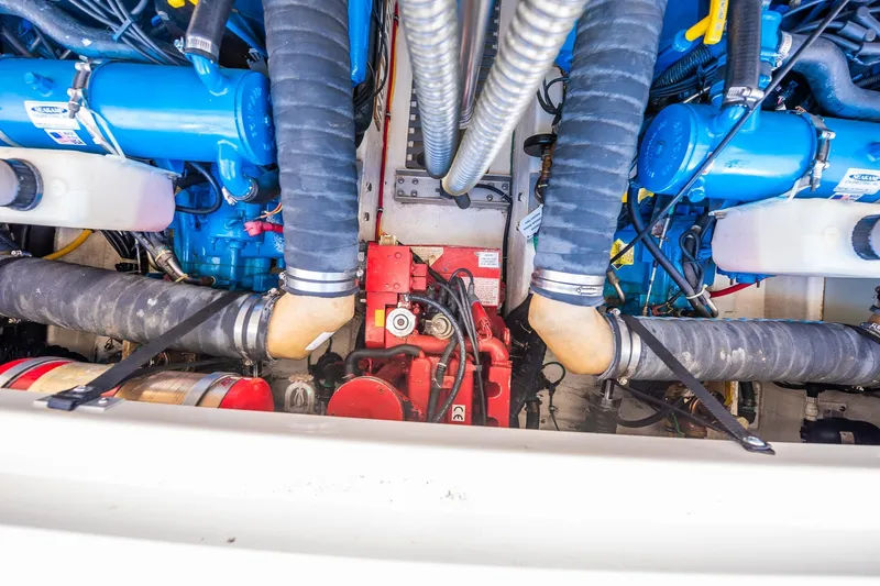 Slide: The Image of Engine compartment of a 2000 Tiara 31 Open boat, featuring blue and red components. - 11
