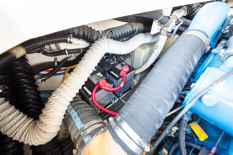 Slide: The Image of Engine compartment of 2000 Tiara 31 Open, featuring hoses and battery connections. - 12