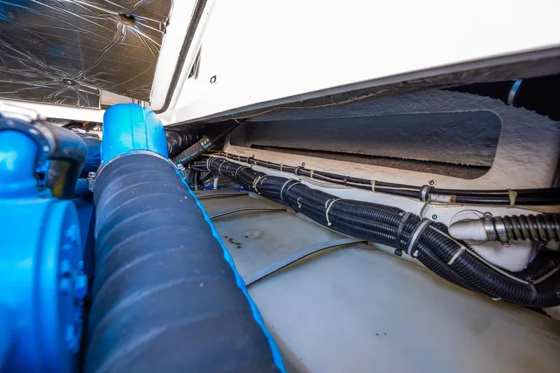 Slide: The Image of Engine compartment of a 2000 Tiara 31 Open boat, showcasing hoses and wiring. - 13