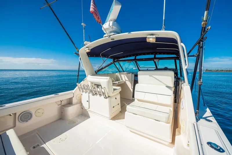 Slide: The Image of 2000 Tiara 31 Open boat with spacious deck and seating, cruising on calm blue waters. - 14