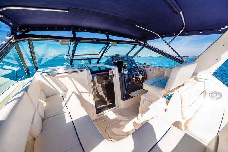 Slide: The Image of Interior of 2000 Tiara 31 Open yacht with helm, seating, and ocean view. - 16