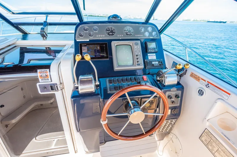 Slide: The Image of Cockpit of 2000 Tiara 31 Open boat with steering wheel and navigation controls. - 17