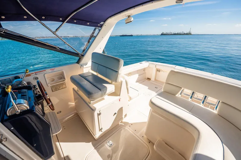 Slide: The Image of 2000 Tiara 31 Open yacht interior with ocean view, featuring comfortable seating and helm station. - 18