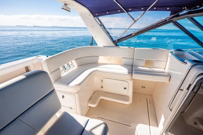 Slide: The Image of 2000 Tiara 31 Open yacht interior with white seating and ocean view. - 19