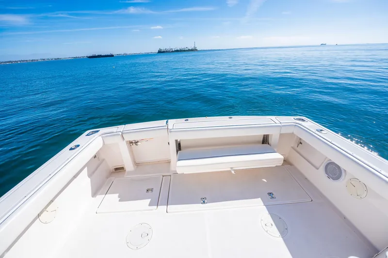 Slide: The Image of 2000 Tiara 31 Open boat deck with ocean view under clear blue sky. - 21
