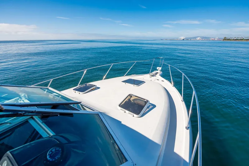 Slide: The Image of Bow view of 2000 Tiara 31 Open yacht cruising on calm blue waters. - 22