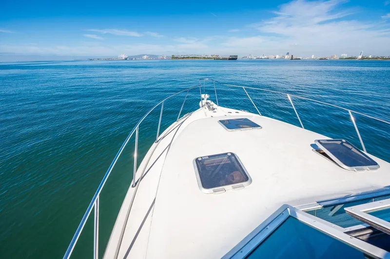 Slide: The Image of Bow view of 2000 Tiara 31 Open yacht cruising on calm blue waters. - 23