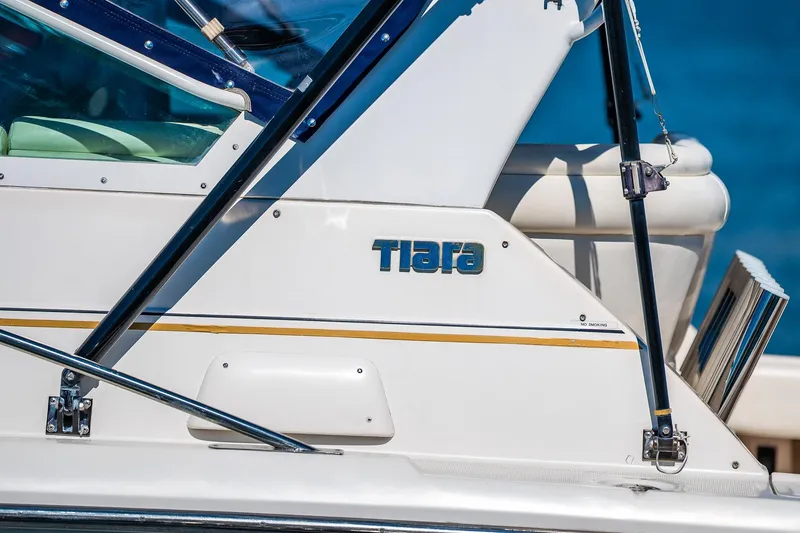 Slide: The Image of 2000 Tiara 31 Open boat side view with logo and railing. - 24