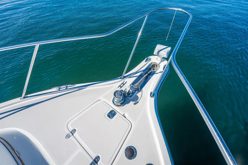 Slide: The Image of Bow of 2000 Tiara 31 Open boat on calm blue water. - 25