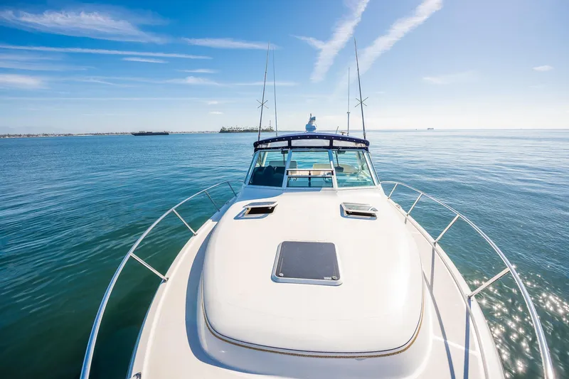 Slide: The Image of 2000 Tiara 31 Open yacht cruising on calm ocean waters under clear blue skies. - 27