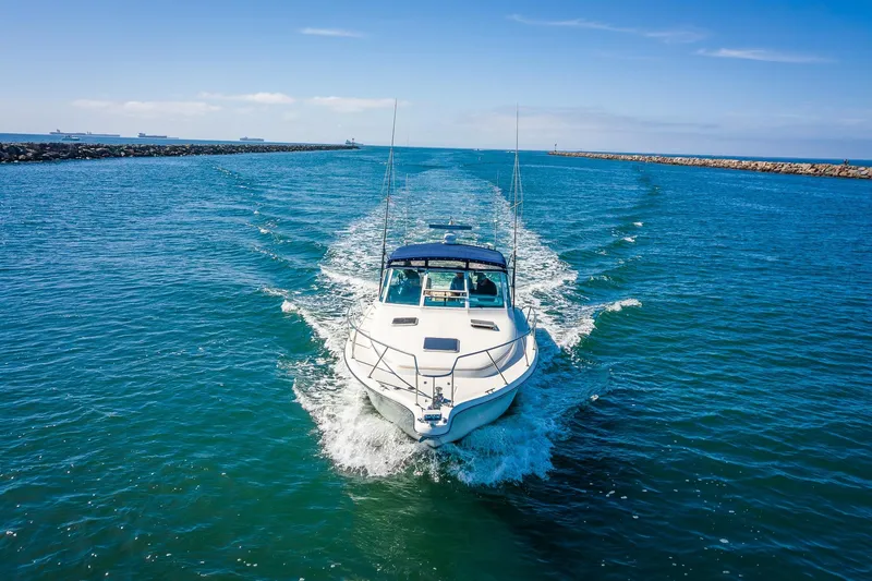 Slide: The Image of 2000 Tiara 31 Open boat cruising in clear blue ocean waters. - 34