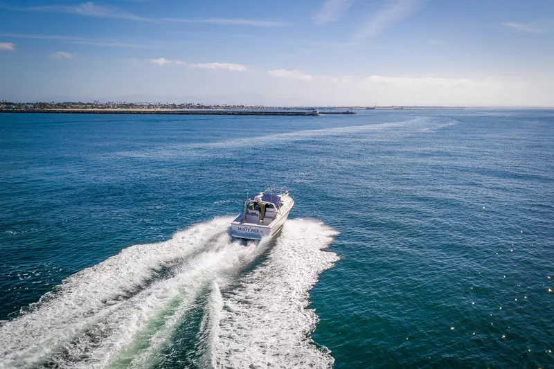 Slide: The Image of 2000 Tiara 31 Open boat cruising on open blue sea under clear sky. - 36