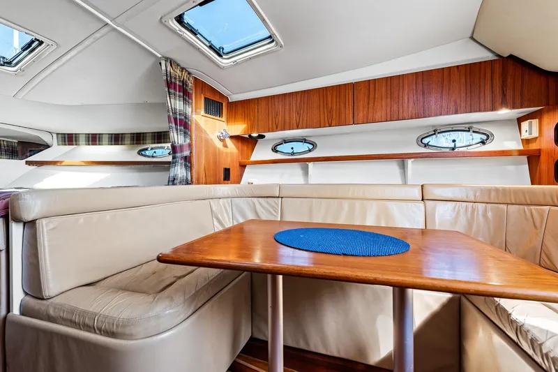Slide: The Image of Interior of 2000 Tiara 31 Open yacht with cozy seating and wooden table. - 7