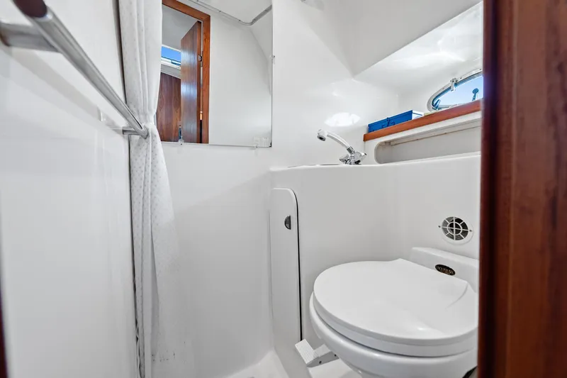 Slide: The Image of Bathroom interior of 2000 Tiara 31 Open boat, featuring toilet and sink. - 9