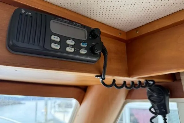 Slide: The Image of 2001 Sabreline Sedan interior with Icom VHF marine radio installed on wooden panel. - 28