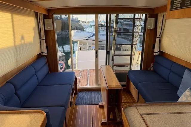 Slide: The Image of Interior of 2001 Sabreline Sedan yacht with blue seating and wooden accents. - 3