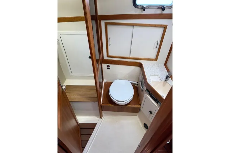 Slide: The Image of 2001 Sabreline Sedan bathroom interior with wooden accents and compact design. - 35