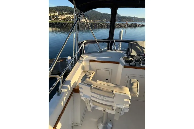 Slide: The Image of 2001 Sabreline Sedan boat interior with helm and scenic water view. - 43