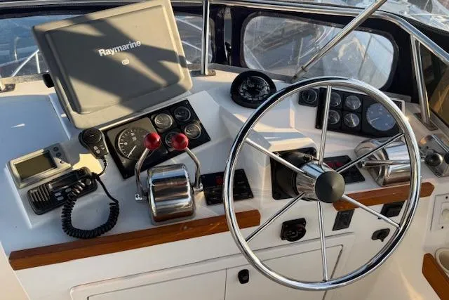 Slide: The Image of 2001 Sabreline Sedan helm with steering wheel, navigation equipment, and control panel. - 44