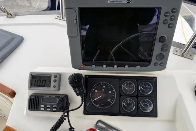 Slide: The Image of Control panel of a 2001 Sabreline Sedan boat with navigation and communication equipment. - 45