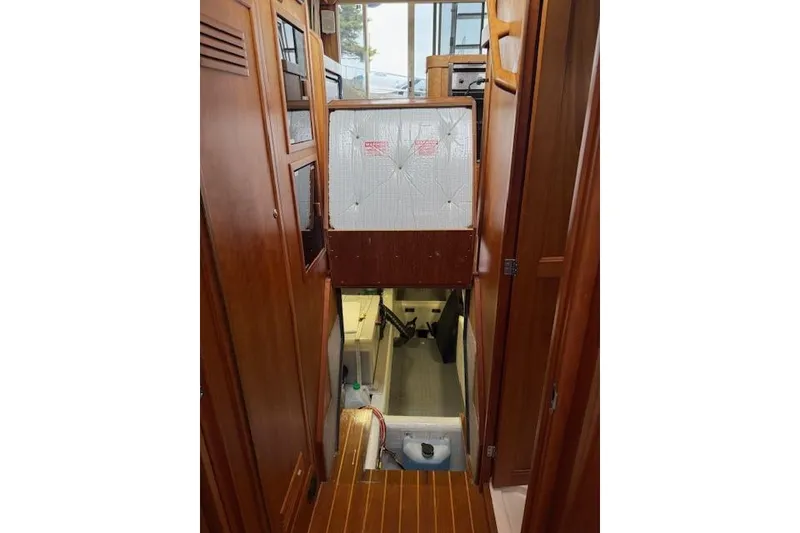 Slide: The Image of Interior view of 2001 Sabreline Sedan, featuring wooden cabinetry and a stairway to lower deck. - 46