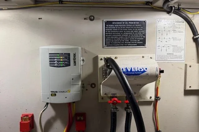 Slide: The Image of Engine room of a 2001 Sabreline Sedan with Xantrex charger and Reverso oil change system. - 54