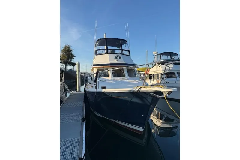 Slide: The Image of 2001 Sabreline Sedan boat docked at marina under clear blue sky. - 7