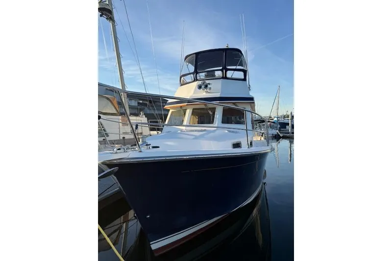 Slide: The Image of 2001 Sabreline Sedan boat docked at marina under clear blue sky. - 8
