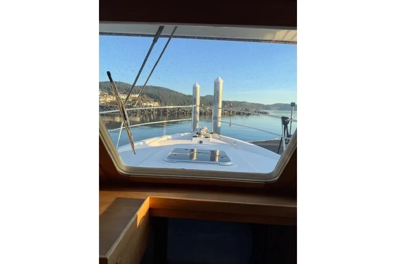 Slide: The Image of View from 2001 Sabreline Sedan boat window, overlooking calm waters and distant hills. - 10