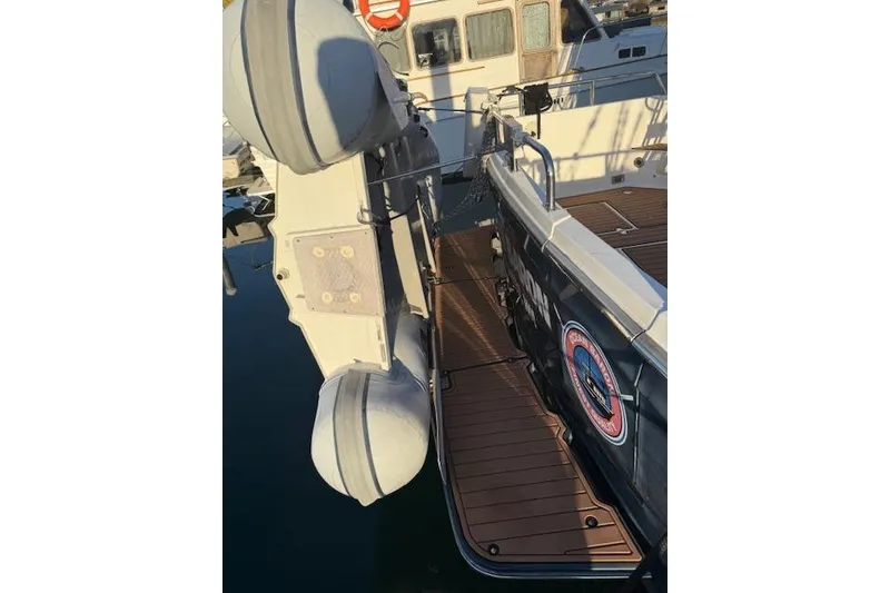 Slide: The Image of 2001 Sabreline Sedan boat docked with inflatable dinghy attached. - 11