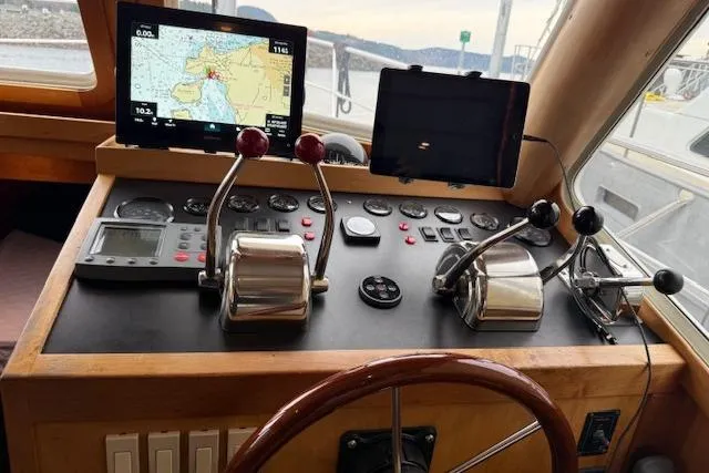 Slide: The Image of Control panel of a 2001 Sabreline Sedan with navigation screens and throttle levers. - 19