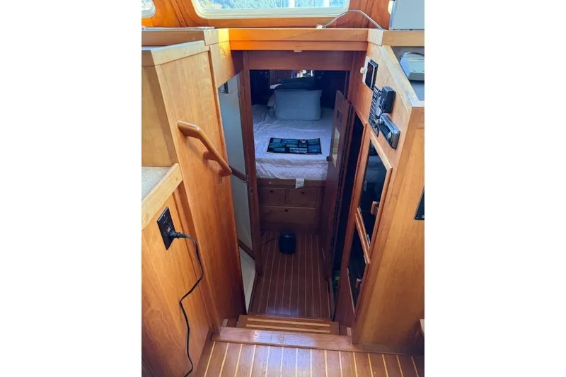 Slide: The Image of 2001 Sabreline Sedan interior with wooden stairs leading to a cozy cabin. - 23