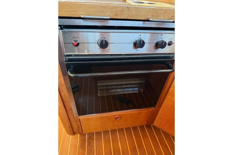 Slide: The Image of Built-in oven on a 2001 Sabreline Sedan boat with wooden cabinetry. - 31