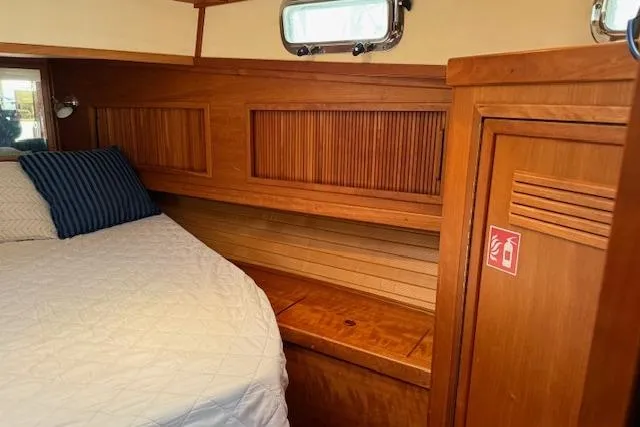 Slide: The Image of 2001 Sabreline Sedan interior with wooden cabinetry and cozy bed. - 40